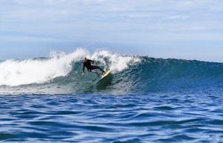 Champion surfer Linda Benson riding a wave at age 79